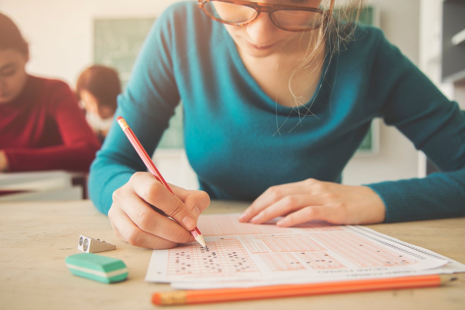 female students takes test with wholesale school supplies