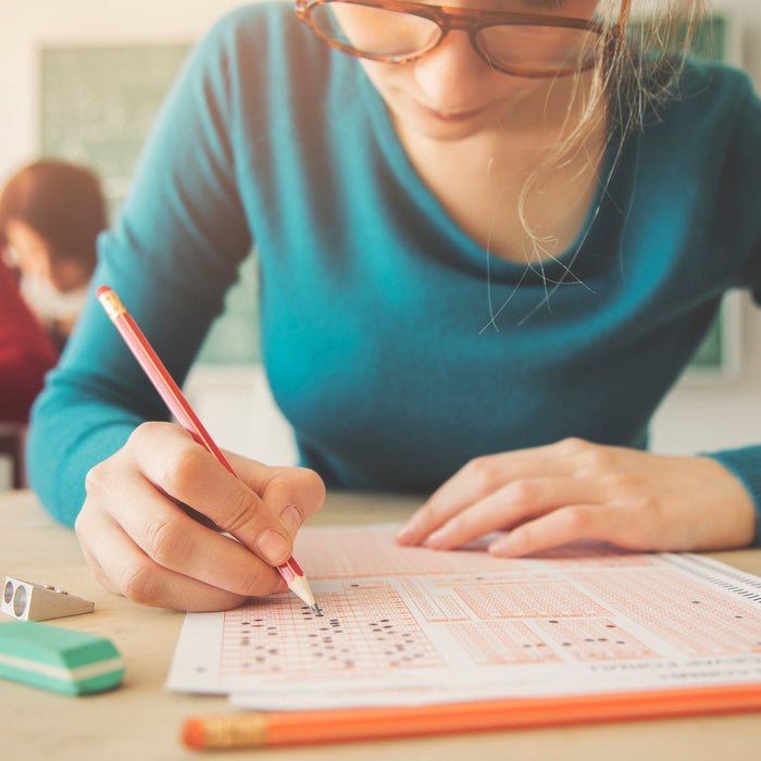 female students takes test with wholesale school supplies