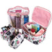 4-piece Paris & Roses print cosmetic set: clear case, printed case, and two small pouches filled with beauty products.