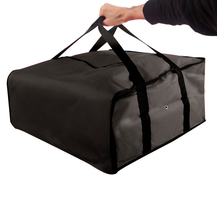 Hand holding a black Trailmaker insulated pizza carrier with top handles and Velcro closure.