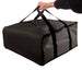Hand holding a black Trailmaker insulated pizza carrier with top handles and Velcro closure.