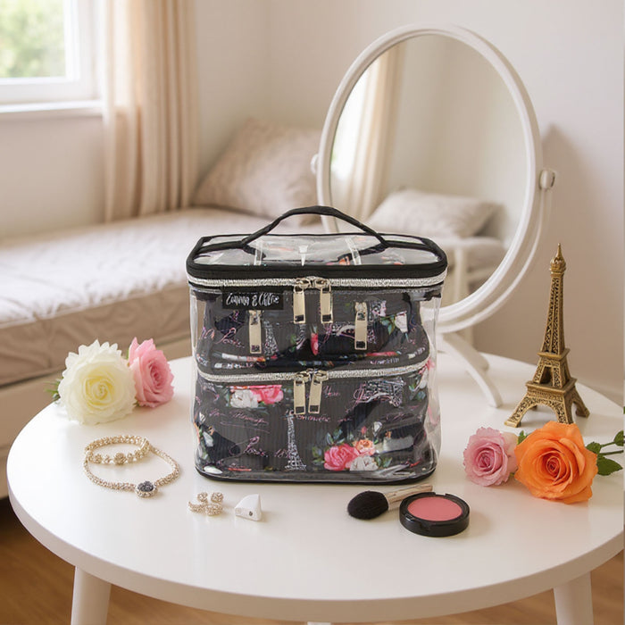Clear and black 4-piece Paris print cosmetic set with floral accents, reinforced handles, and silver zippers.
